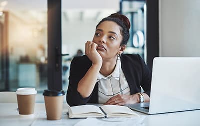 Woman bored at laptop
