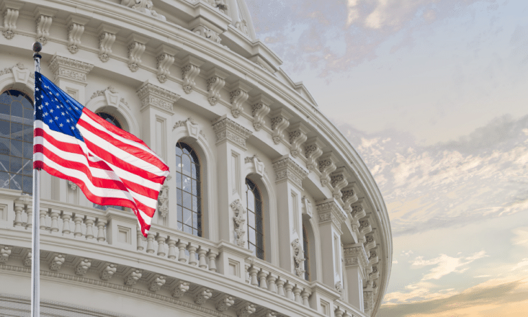 Washington DC Capitol dome detail with waving American flag