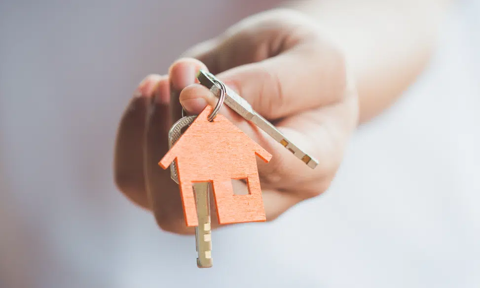hand holding house key