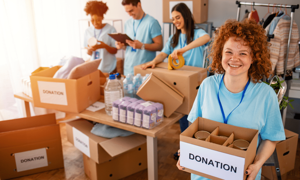 woman holding box of donations for volunteer event