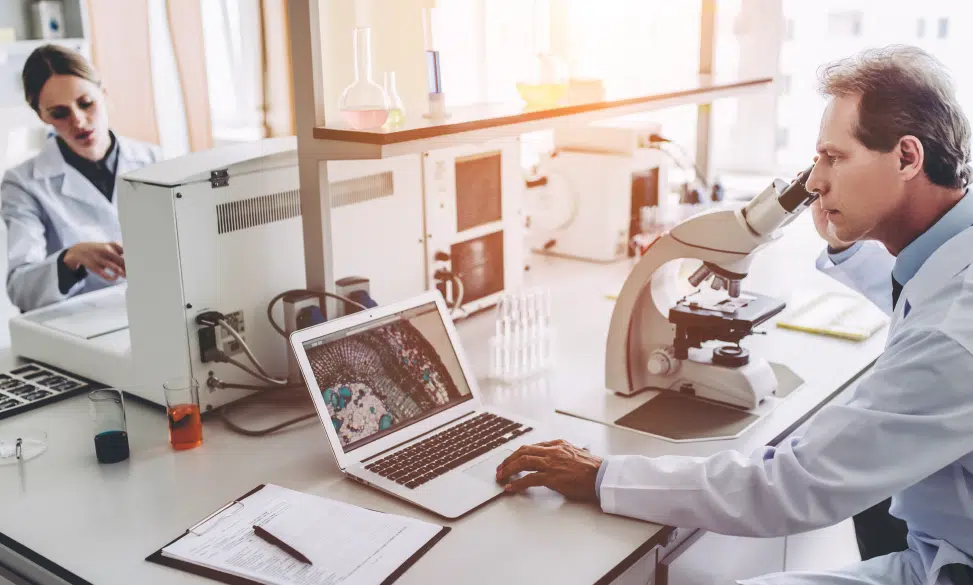 scientists working on lab equipment