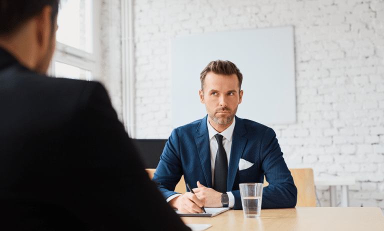 Job interview with businessman listening to candidate answers