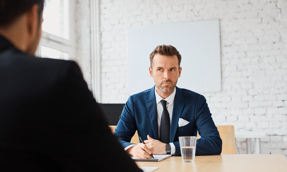 Job interview with businessman listening to candidate answers