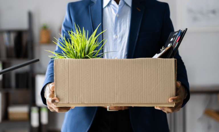 man walking out of office after being laid off