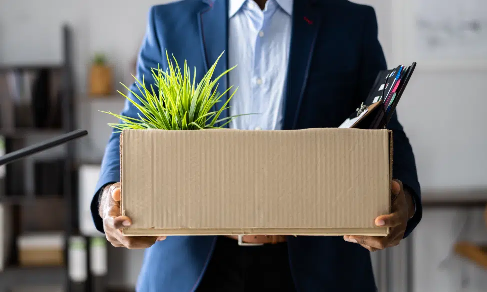 man walking out of office after being laid off