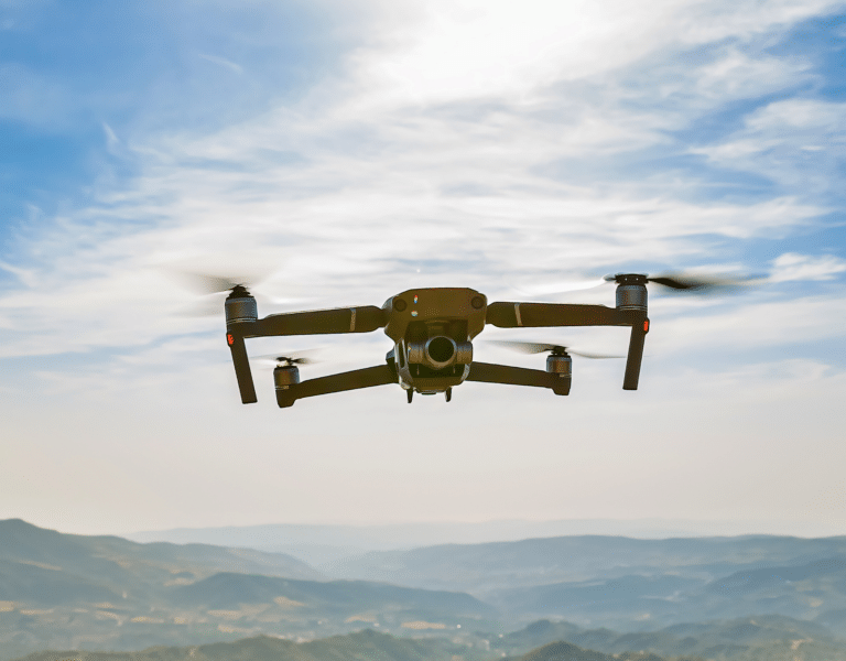 A drone flying over a landscape, showcasing advanced drone technology used for environmental inspections.